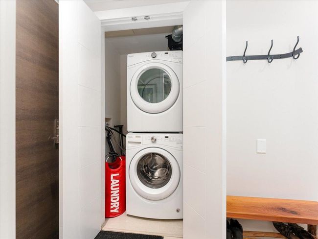 Laundry area with stacked washer and clothes dryer | Image 21