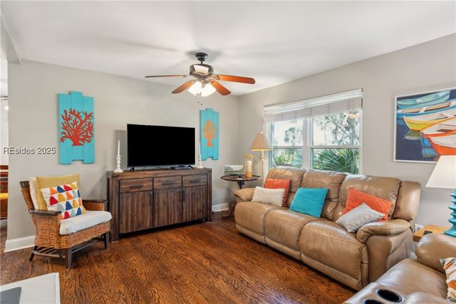 Primary living room with hardwood floors, ample seating, bright natural lighting, smooth ceilings. | Image 37
