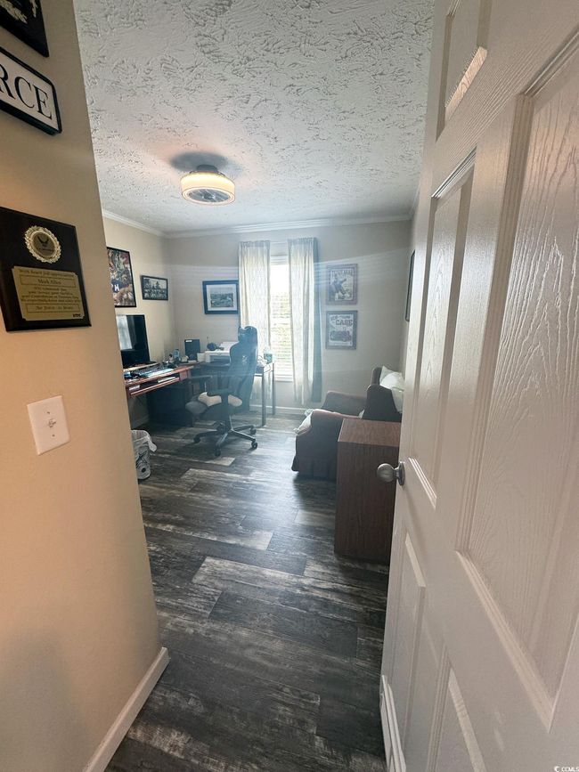 Home office with ornamental molding, wood finished floors, and a textured ceiling | Image 25