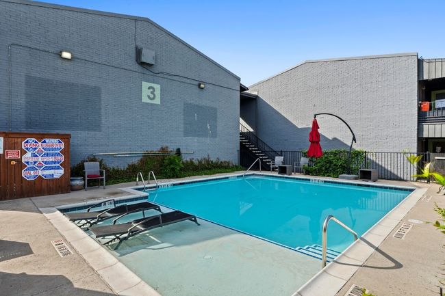 Community pool with stairway, fence, and a patio | Image 25