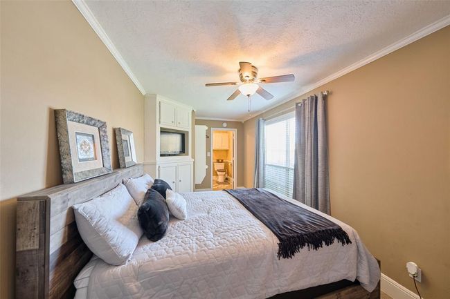 Private bedroom in the guest suite has access to one of the garages & a washer & dryer | Image 13