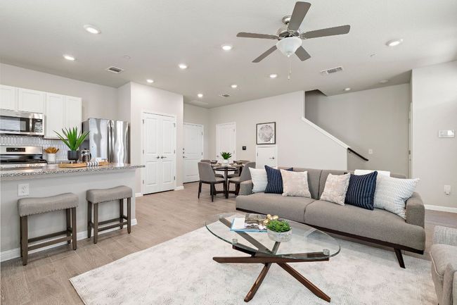 Living room featuring light wood finished floors, a ceiling fan, and recessed lighting | Image 9