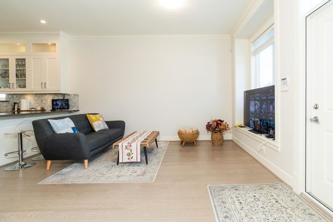 Living area with crown molding, light wood-style floors, recessed lighting, and baseboards | Image 9