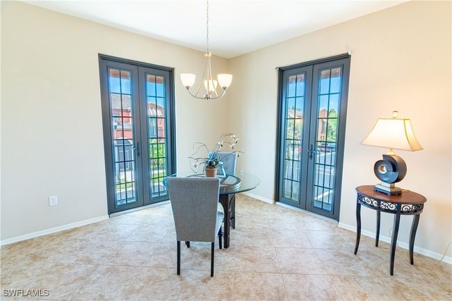 Dining room featuring french doors, baseboards, and an inviting chandelier | Image 13