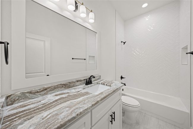 Bathroom with vanity, toilet, shower / washtub combination, and recessed lighting | Image 10