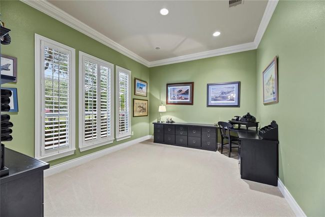 Spacious Library / Study with view of mature oak trees that shade the front yard and wooden shutters that let in the afternoon and evening glow of the sun. | Image 5