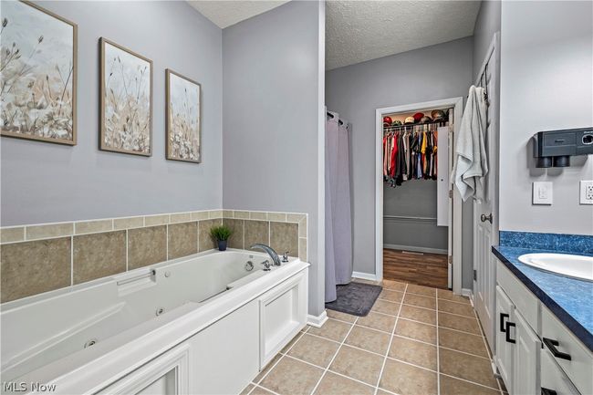 Bathroom featuring tile flooring, a textured ceiling, and​​‌​​​​‌​​‌‌​‌‌​​​‌‌​​‌‌​‌​​​​​‌ vanity | Image 24