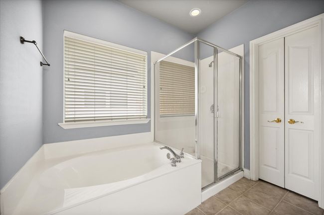 Bathroom with a garden tub, a shower stall, and tile patterned flooring | Image 16