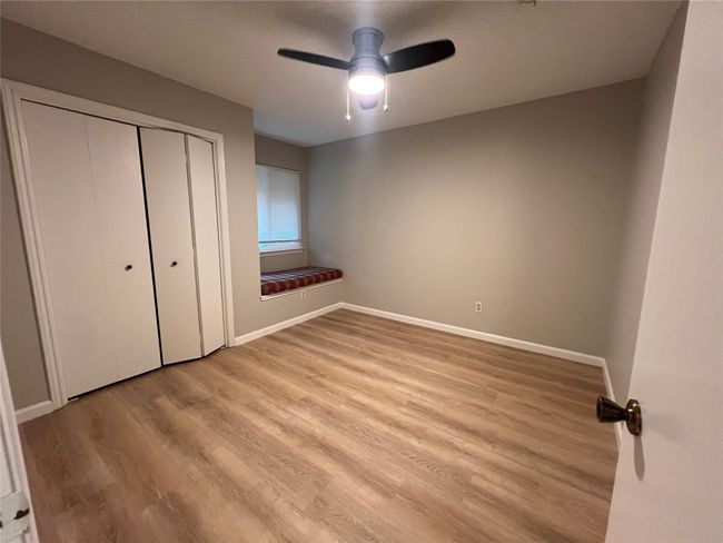 Unfurnished bedroom featuring light wood-type flooring, a closet, baseboards, and a ceiling fan | Image 18