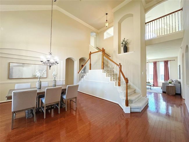 Stair way makes a statement, gleaming wood floors throughout the downstairs. Glass lead mahogany door greets you as you walk in. | Image 4
