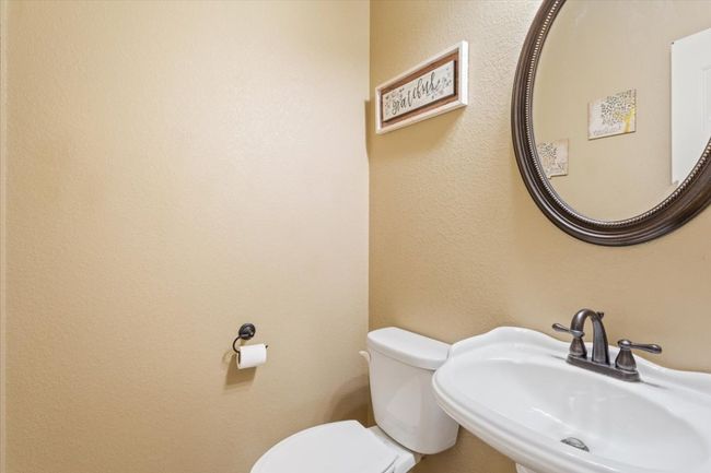 Bathroom featuring a sink and toilet | Image 30