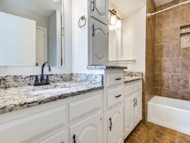 Bathroom with vanity and washtub / shower combination | Image 16