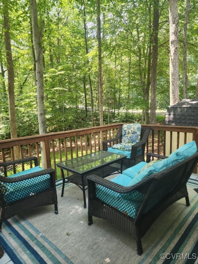 Deck with an outdoor living space and a forest view | Image 23