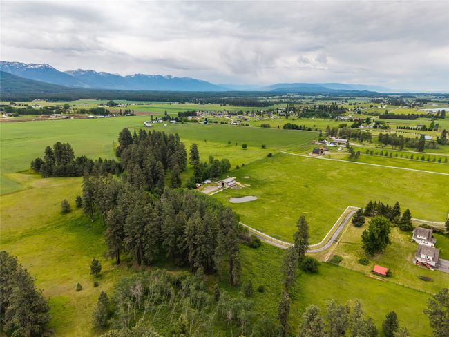 Overview of rural landscape featuring a mountain backdrop and a pastoral area | Image 53