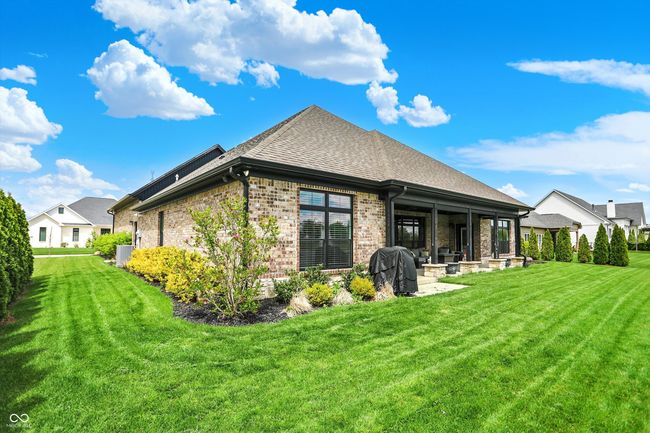 rear view of property with a lawn, brick siding, central AC, and a shingled roof | Image 42