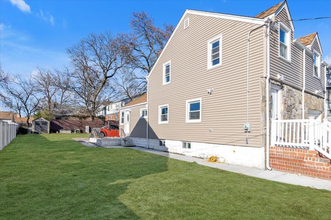 View of property exterior with a yard and a shed | Image 17