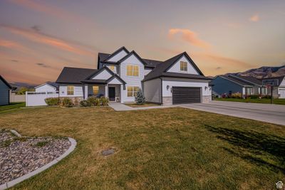 Craftsman-style home featuring a garage and a yard | Image 1