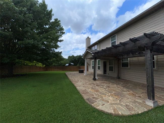 View of yard featuring a pergola and a patio | Image 28