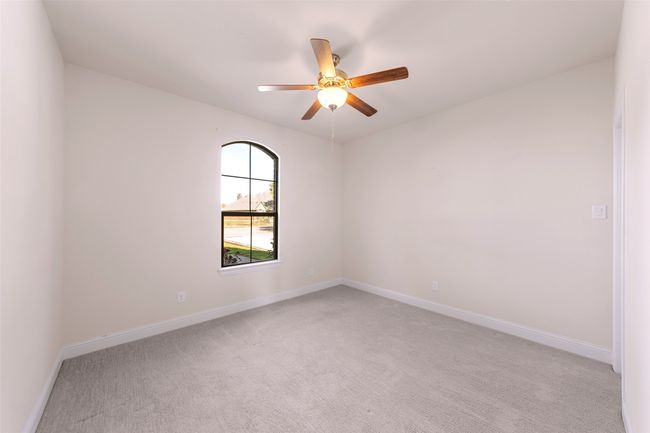 Front Guest Bedroom with ceiling fan and walk-in closet to the right. | Image 17