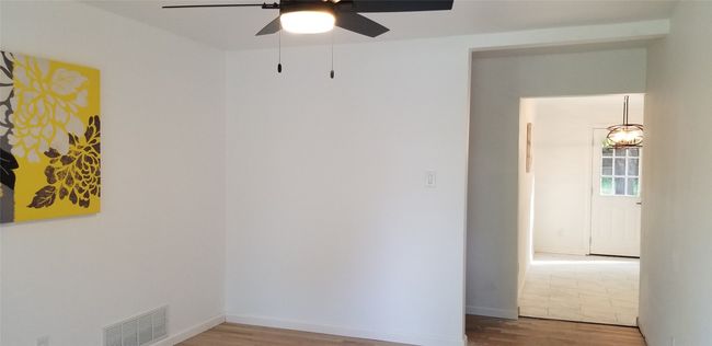 Empty room featuring wood finished floors, ceiling fan, and baseboards | Image 22