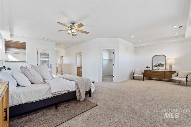 Carpeted bedroom featuring recessed lighting, a spacious closet, ceiling fan, and ensuite bathroom | Image 29
