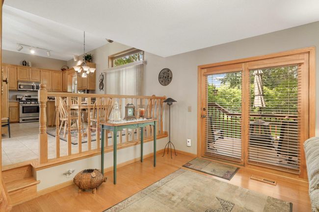 Step down into living room with deck access. | Image 18