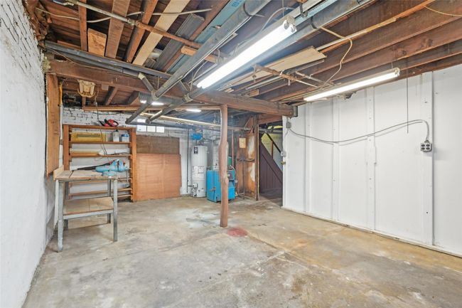 Unfinished basement with water heater and a heating unit | Image 30