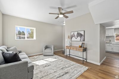 Living room featuring light hardwood / wood-style flooring and ceiling fan | Image 3