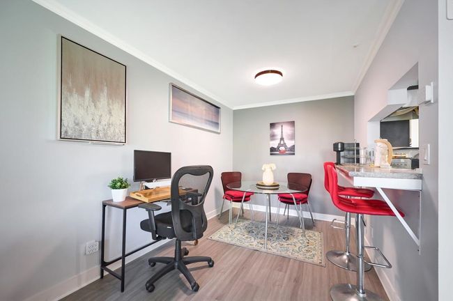 Office area featuring crown molding, baseboards, and wood finished floors | Image 6