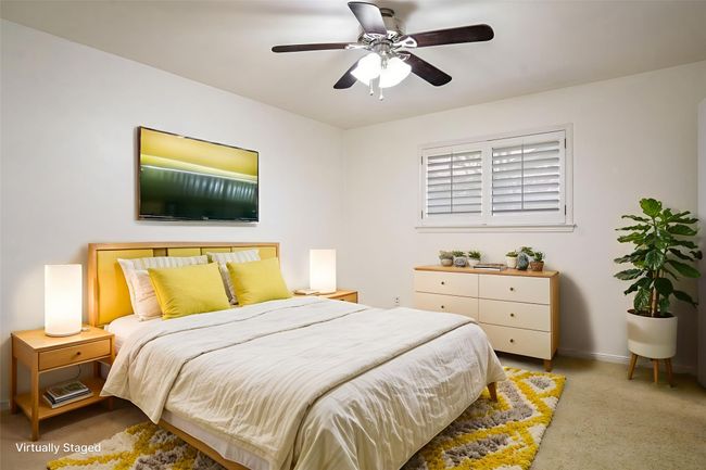 Bedroom with light colored carpet and a ceiling fan | Image 20
