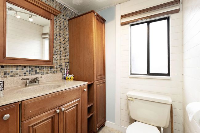 Bathroom with vanity and healthy amount of natural light | Image 24