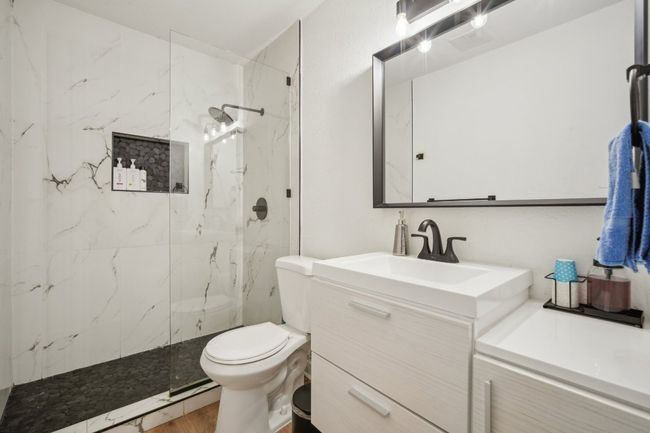 Updated bath w/glass enclosed shower, vessel sink and quartz counter. | Image 15