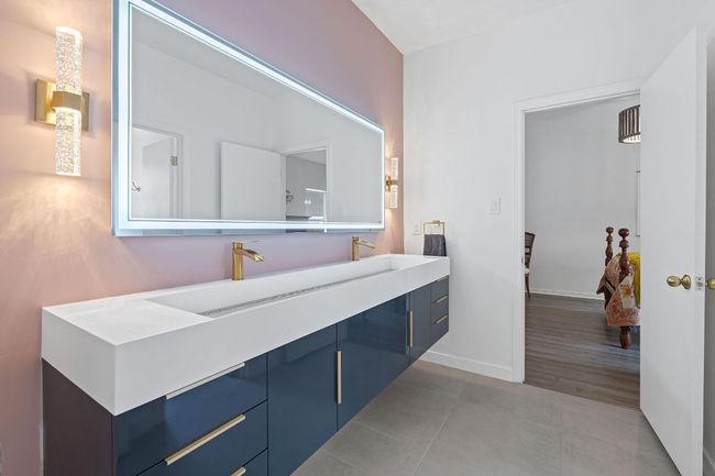 Bathroom with double vanity and tile patterned floors | Image 29