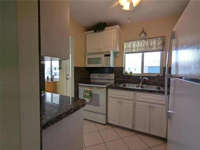 Kitchen - diagonal tile flooring (note the updated windows) | Image 7