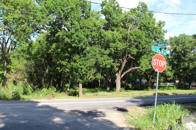 View of asphalt street featuring traffic signs | Image 5