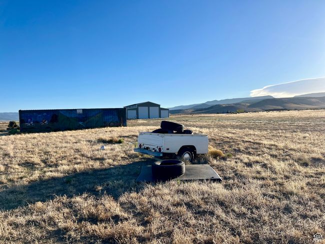 View of yard with a mountain view and an outdoor structure | Image 15