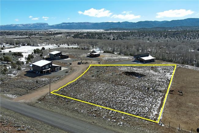 Aerial overview of property's location with a mountainous background and property boundaries highlighted | Image 24