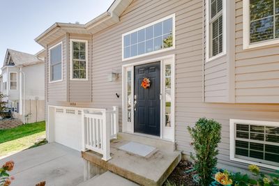 Doorway to property with a garage | Image 2