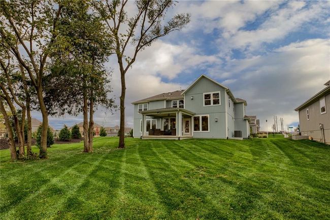 Back of property featuring central AC and a lawn | Image 46