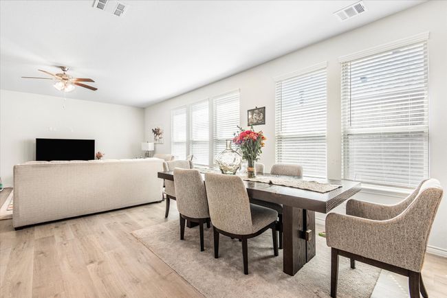 Dining space featuring light wood-style floors, visible vents, and a ceiling fan | Image 8