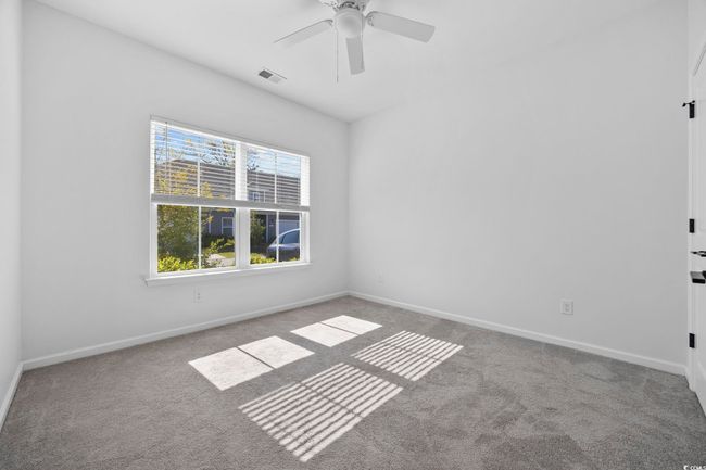 Empty room featuring baseboards, carpet floors, ceiling fan, and visible vents | Image 18