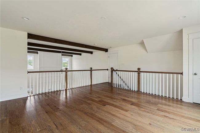 Spare room featuring wood finished floors, beam ceiling, and recessed lighting | Image 24