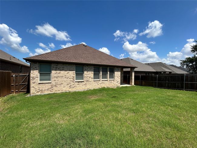 Back of property with brick siding and a shingled roof | Image 31