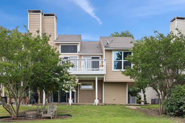 Rear view of house featuring a chimney, a balcony, a yard, roof with shingles, and central air condition unit | Image 24