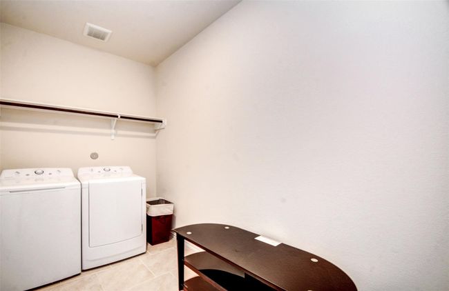 The oversized laundry room offer plenty of space for extra storage. | Image 21