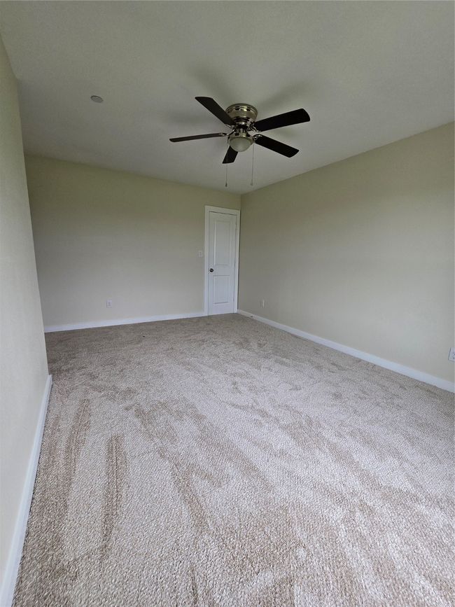 Spare room featuring ceiling fan, carpet, and baseboards | Image 31