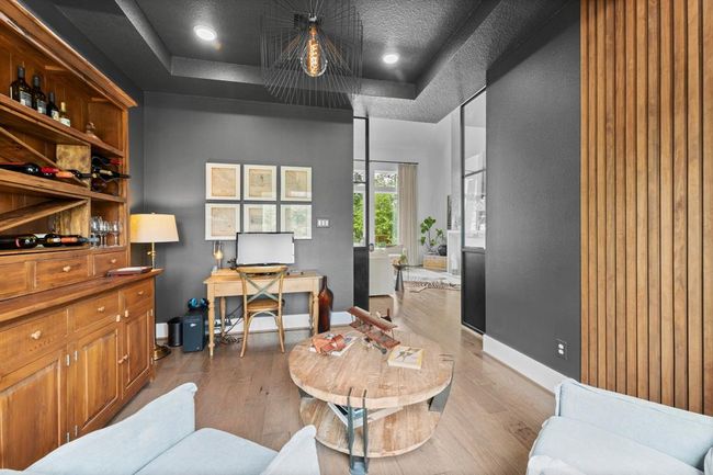Custom accent paint and slat wall treatment gives high design in this home office. | Image 15