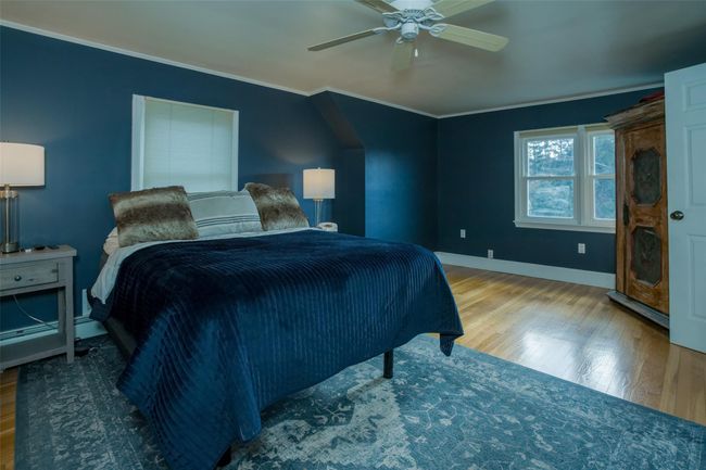 Bedroom with hardwood / wood-style floors, ceiling fan, and crown molding | Image 20