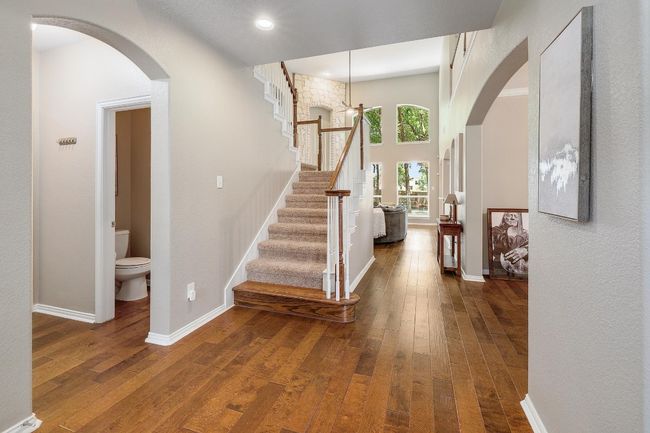 As you walk towards the living room, you will be greeted by the staircase that leads to the 2nd floor, the formal dining area and the half bathroom | Image 10