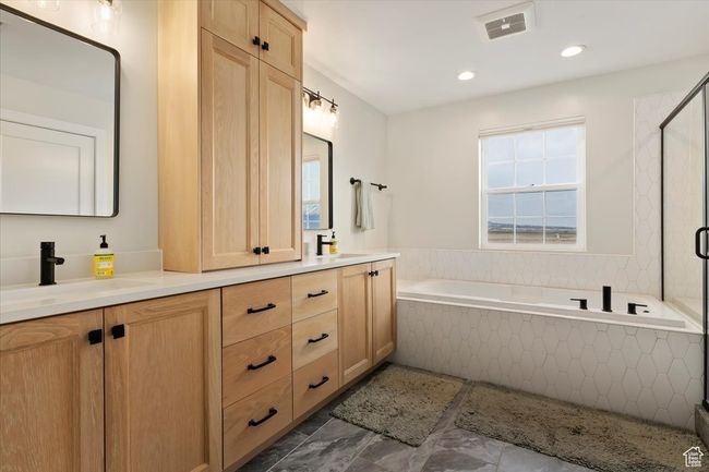 Bathroom with a bath, a sink, double vanity, a stall shower, and visible vents | Image 19